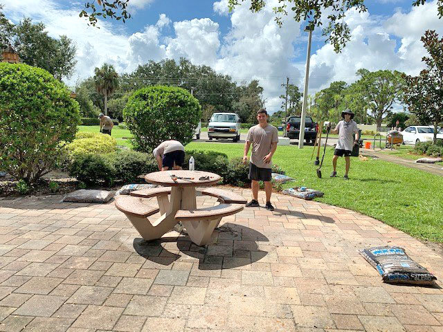 Arthrex volunteers Chris Pomponi, Joe Mazzola, Maria Ramirez and Mike Ross work on the Immokalee Foundation landscaping project.